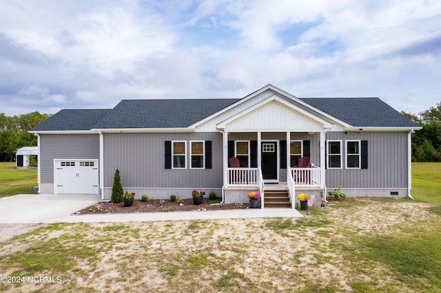 view of front facade with a porch, a garage, and a front yard