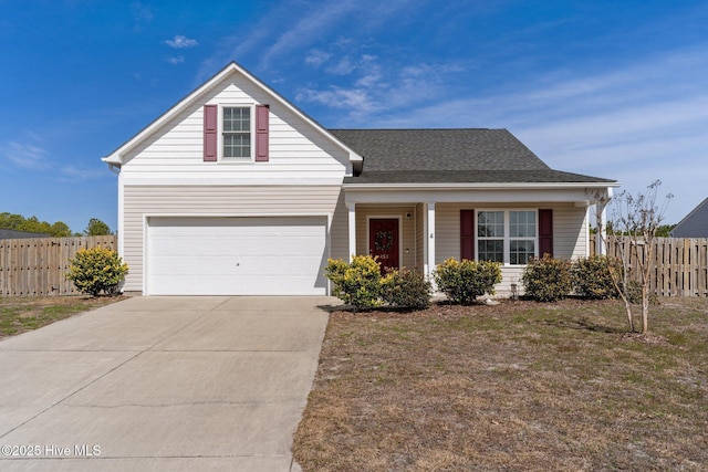 traditional-style house featuring concrete driveway, roof with shingles, fence, and an attached garage