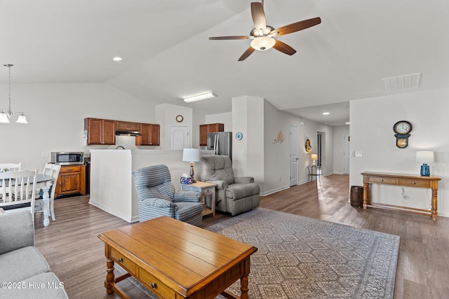 living room with ceiling fan, baseboards, lofted ceiling, light wood-type flooring, and visible vents