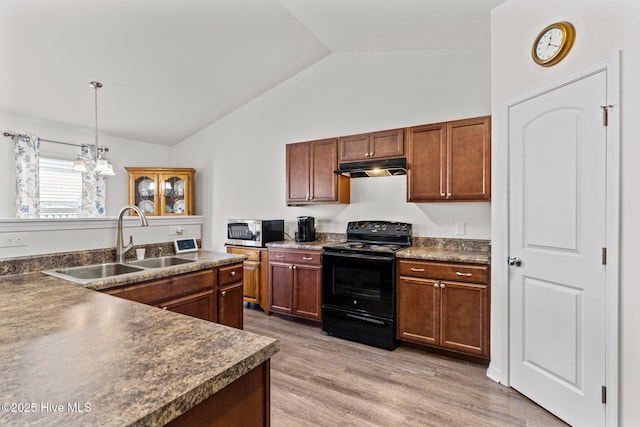 kitchen featuring black electric range, dark countertops, a sink, stainless steel microwave, and lofted ceiling
