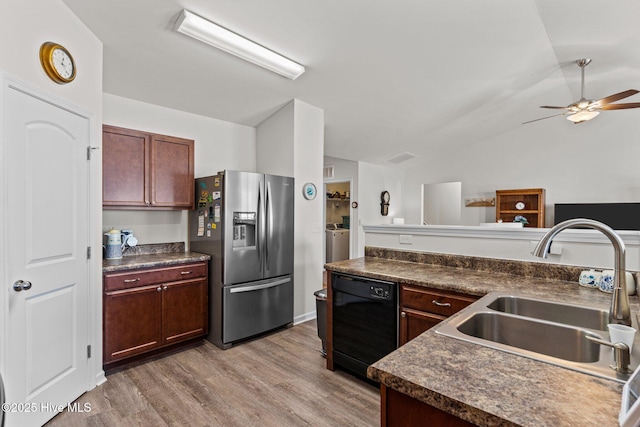kitchen featuring a sink, dark countertops, stainless steel refrigerator with ice dispenser, and dishwasher