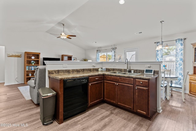 kitchen with a sink, light wood-style floors, and black dishwasher