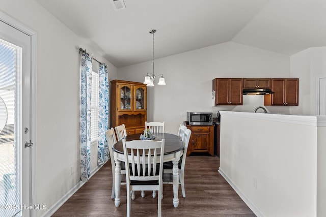 dining space featuring a healthy amount of sunlight, visible vents, lofted ceiling, and a notable chandelier