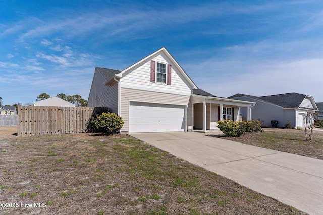 view of front of house with a garage, a front yard, fence, and driveway