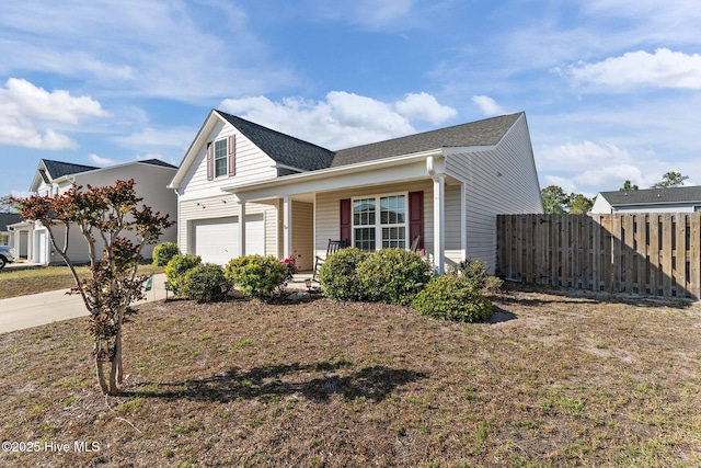 traditional-style house featuring fence, a shingled roof, a porch, and driveway