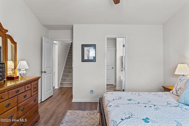 bedroom featuring dark wood-type flooring and baseboards