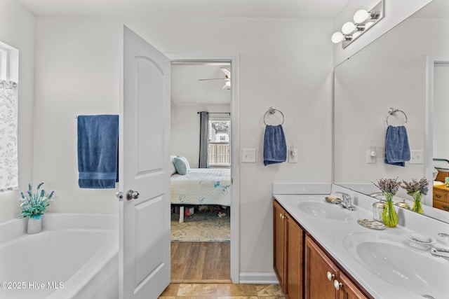 full bath with a sink, ceiling fan, a garden tub, and connected bathroom