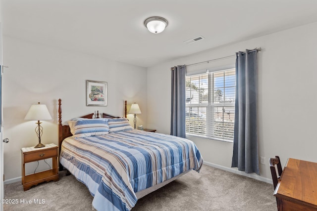bedroom with visible vents, baseboards, and light colored carpet