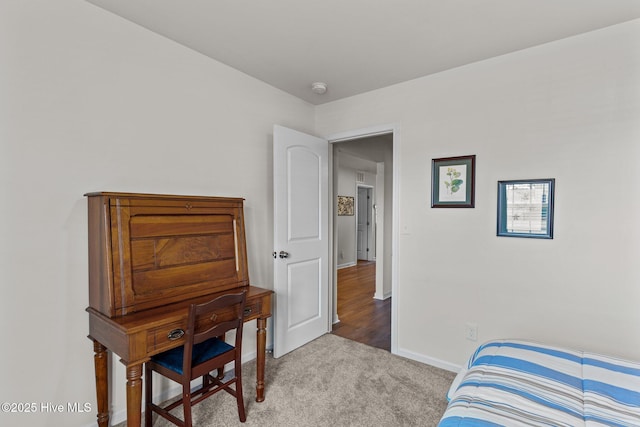 bedroom with carpet floors and baseboards