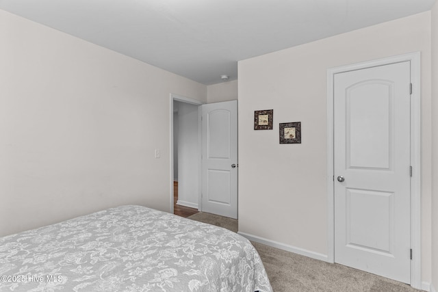 carpeted bedroom with baseboards