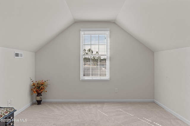 additional living space with carpet floors, baseboards, vaulted ceiling, and visible vents