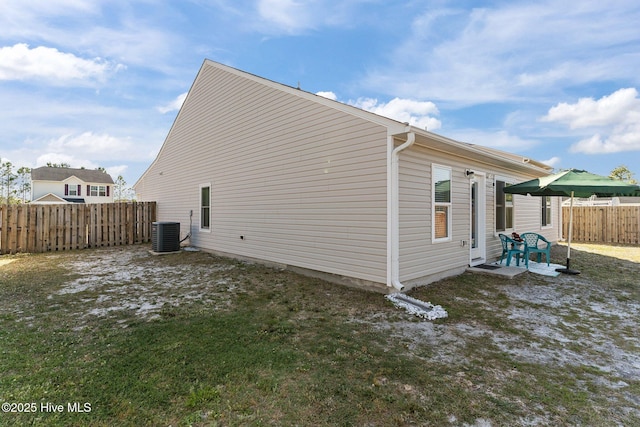 view of property exterior featuring a patio, a fenced backyard, a yard, and cooling unit
