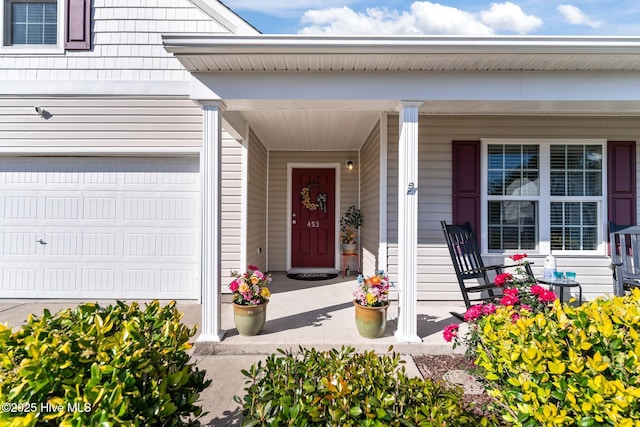 view of exterior entry featuring covered porch