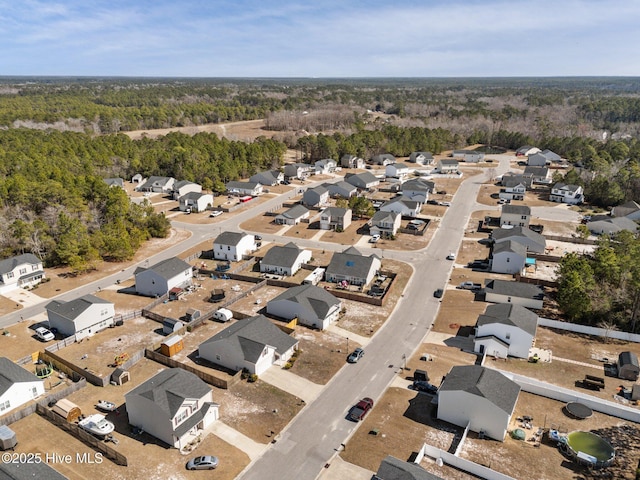 drone / aerial view with a residential view and a view of trees