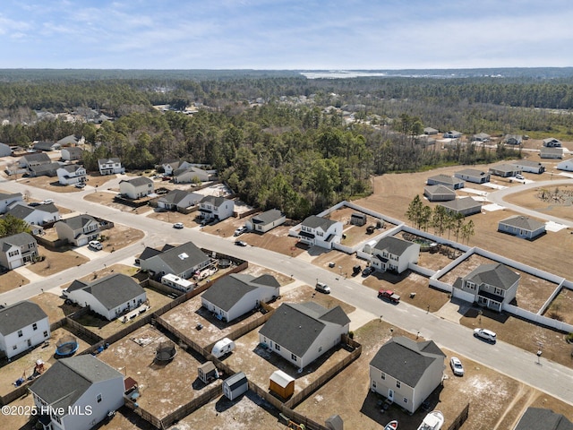bird's eye view featuring a residential view and a wooded view