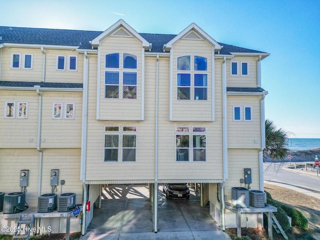 back of property with a carport and central air condition unit