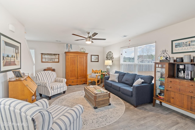 living room featuring ceiling fan and light wood-type flooring