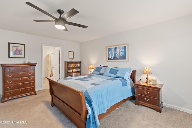 carpeted bedroom featuring ensuite bath and ceiling fan