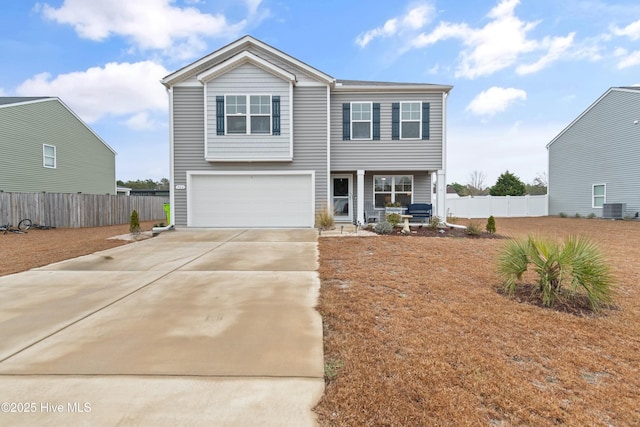 view of front of property featuring cooling unit and a garage