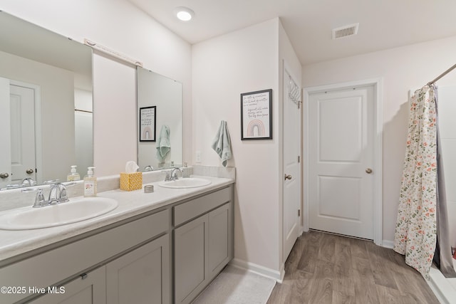 bathroom featuring vanity, hardwood / wood-style flooring, and a shower with shower curtain