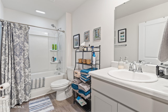 full bathroom featuring vanity, hardwood / wood-style floors, toilet, and shower / bath combo