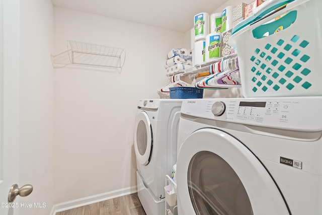 washroom featuring hardwood / wood-style floors and washer and clothes dryer