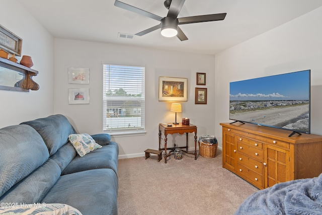 living room featuring light colored carpet and ceiling fan