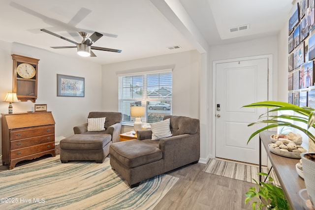 living area with ceiling fan and light wood-type flooring