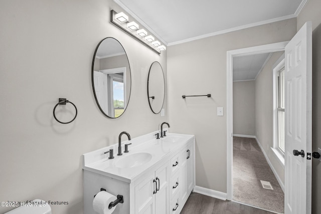 bathroom featuring hardwood / wood-style flooring, vanity, and ornamental molding