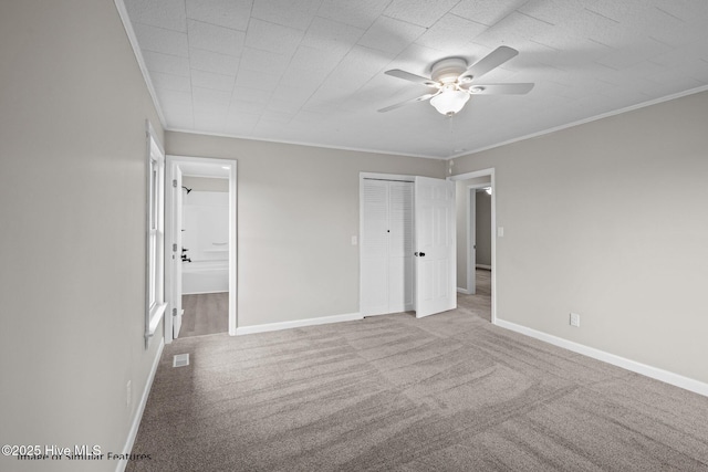 unfurnished bedroom featuring ceiling fan, ornamental molding, and light colored carpet