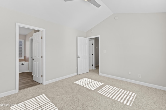 unfurnished bedroom with vaulted ceiling, carpet, and baseboards