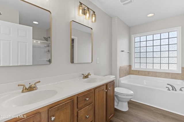 bathroom with a shower, a garden tub, a sink, and wood finished floors