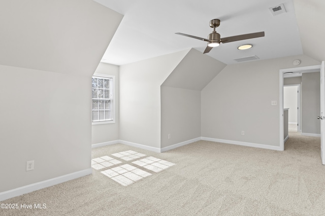 bonus room featuring carpet floors, baseboards, visible vents, and lofted ceiling