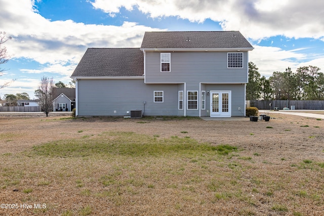 back of house featuring central AC, a shingled roof, fence, french doors, and a lawn