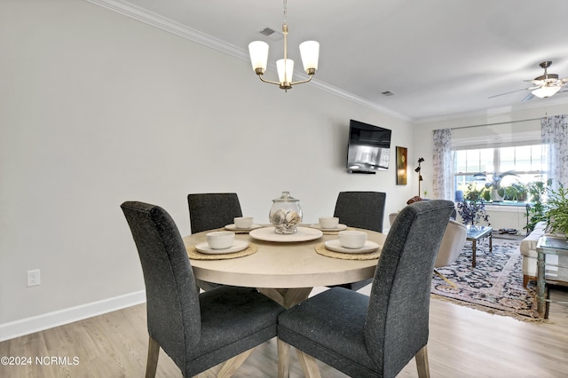 dining area with ornamental molding, ceiling fan with notable chandelier, and light hardwood / wood-style floors