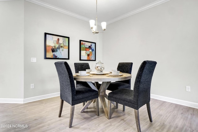 dining area with hardwood / wood-style flooring, crown molding, and a notable chandelier