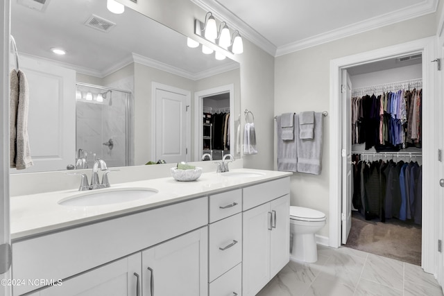 bathroom featuring vanity, ornamental molding, a shower with door, and toilet