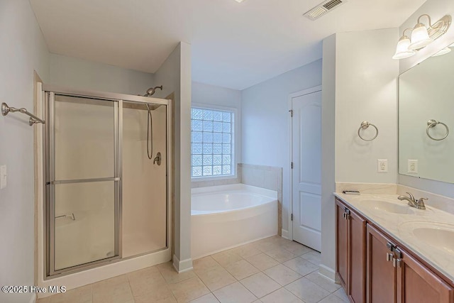 bathroom featuring plus walk in shower, tile patterned floors, and vanity