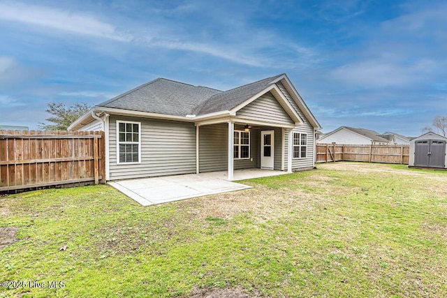 back of house with a yard and a patio area