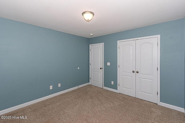 unfurnished bedroom with carpet floors and a closet