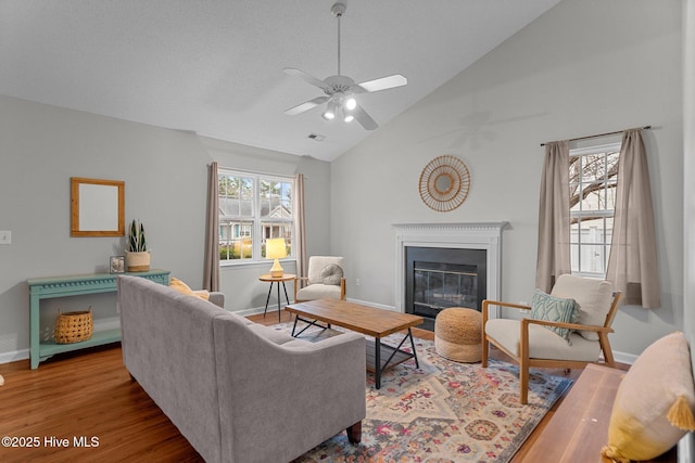 living room with ceiling fan, high vaulted ceiling, and light hardwood / wood-style floors