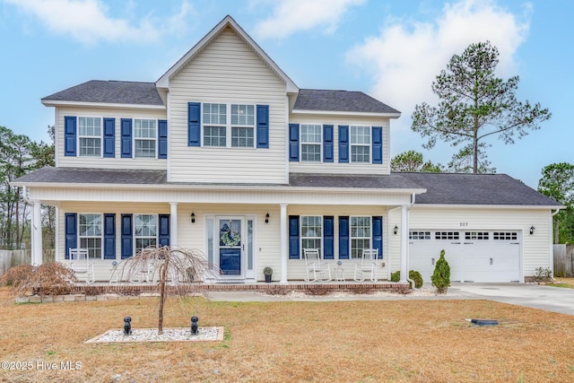 traditional-style house with a garage, concrete driveway, roof with shingles, covered porch, and a front yard