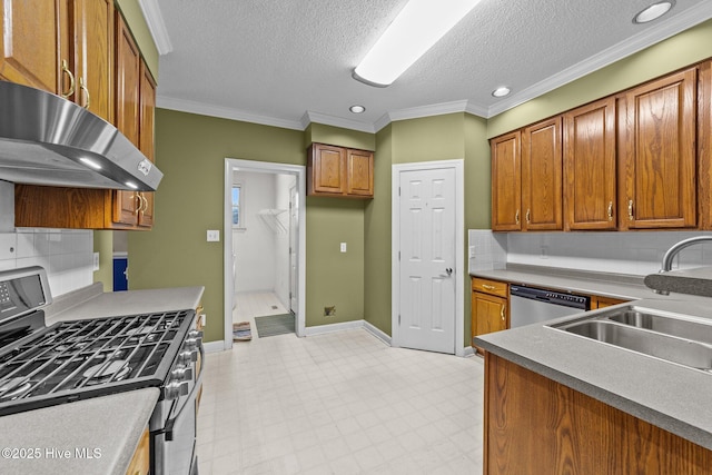 kitchen featuring crown molding, brown cabinets, under cabinet range hood, and stainless steel appliances