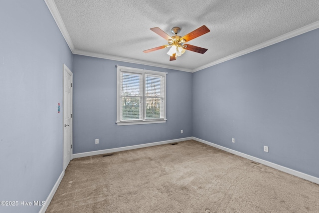 unfurnished room with ceiling fan, baseboards, carpet floors, and ornamental molding