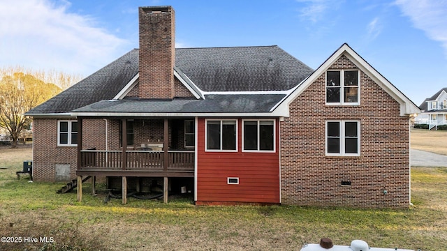 rear view of property featuring crawl space, a chimney, and a yard