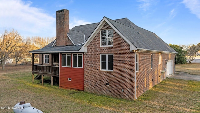 view of property exterior featuring brick siding, a lawn, a chimney, a garage, and crawl space