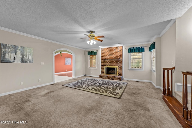 unfurnished living room featuring arched walkways, carpet flooring, and crown molding