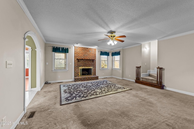 unfurnished living room featuring arched walkways, plenty of natural light, carpet flooring, and visible vents