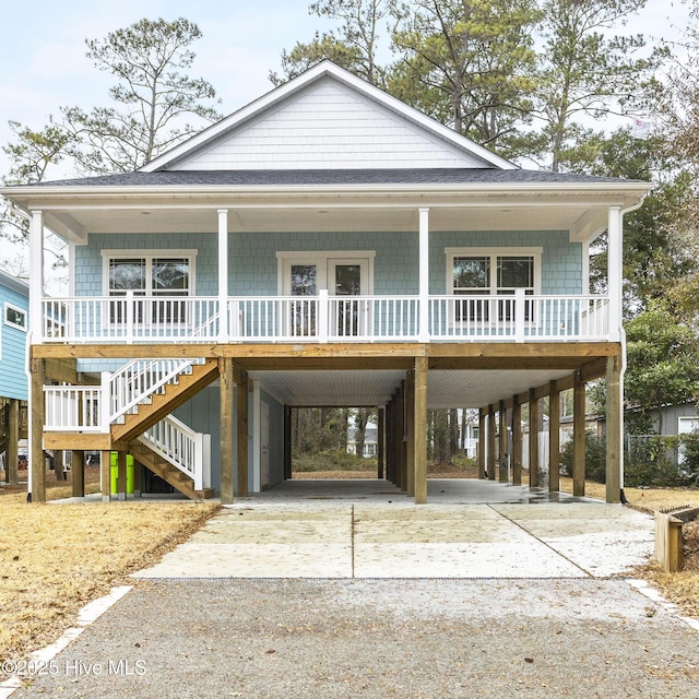 coastal home featuring a carport and covered porch