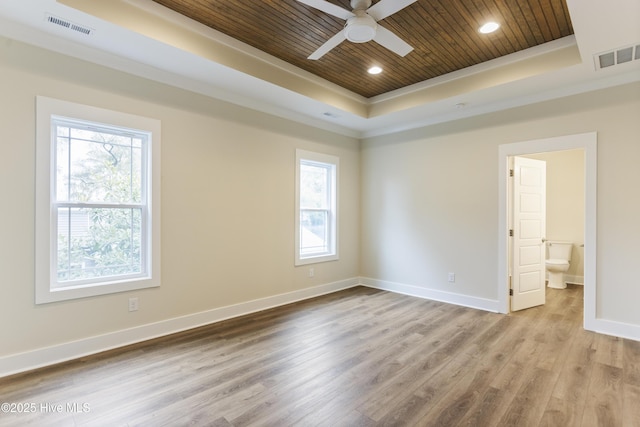 unfurnished room featuring a healthy amount of sunlight, wooden ceiling, light hardwood / wood-style floors, and a tray ceiling